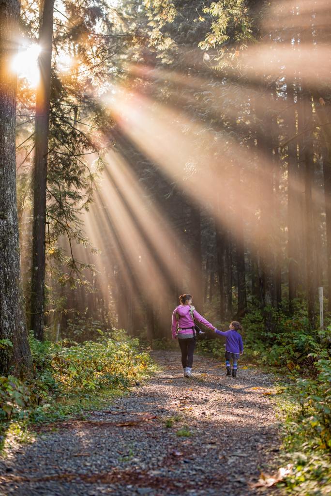 Mother and daughter hiking in the woods with 'heaven slides'