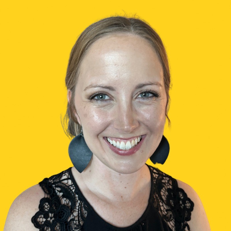 Photo of Laura smiling with a bright yellow background